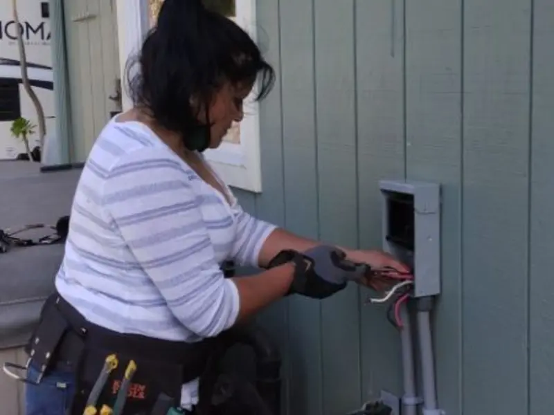 Licensed electrician wiring an exterior subpanel in Katy