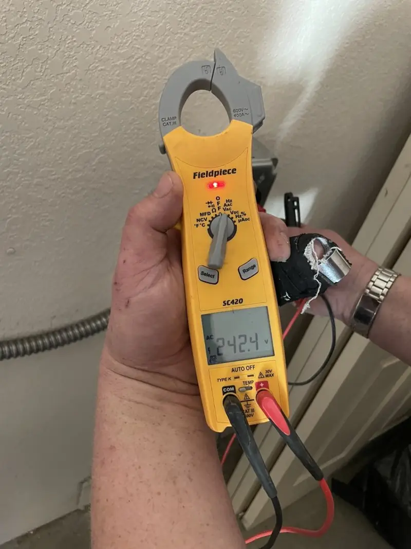 Voltage testing with clamp meter during Whole House Surge Protector in Katy